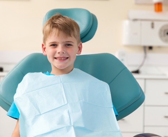 Young boy smiling in dental chair