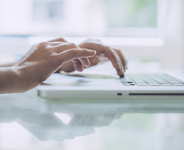 Person typing on laptop