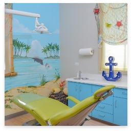 Pediatric dental treatment room with beach painting on wall