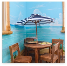 Table in waiting area with beach umbrella