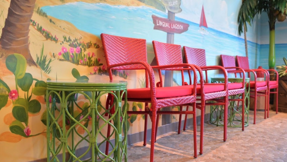 Red chairs and green end table in waiting room