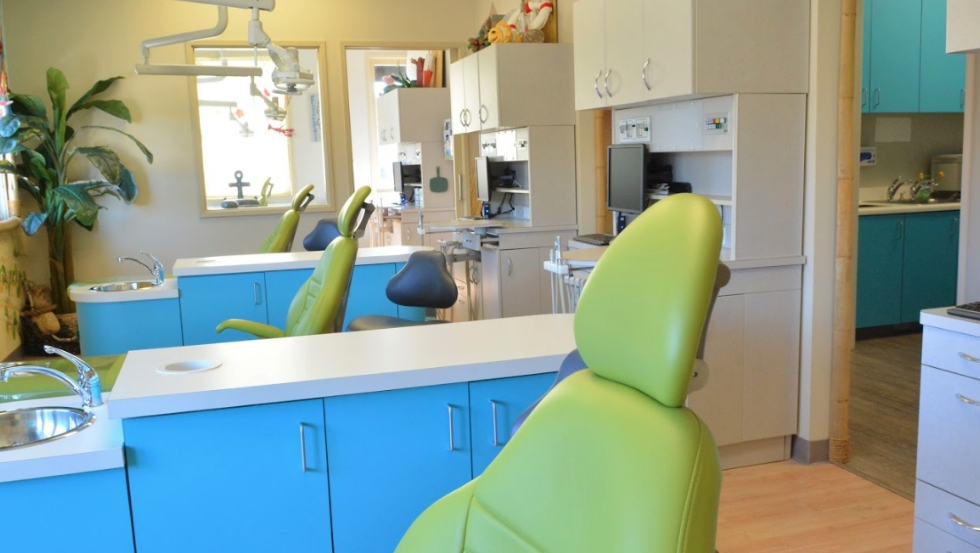 Row of green dental treatment chairs