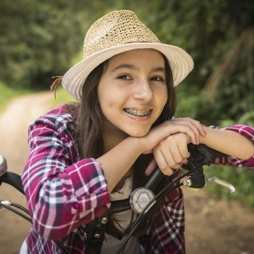 Young girl with braces smiling outdoors