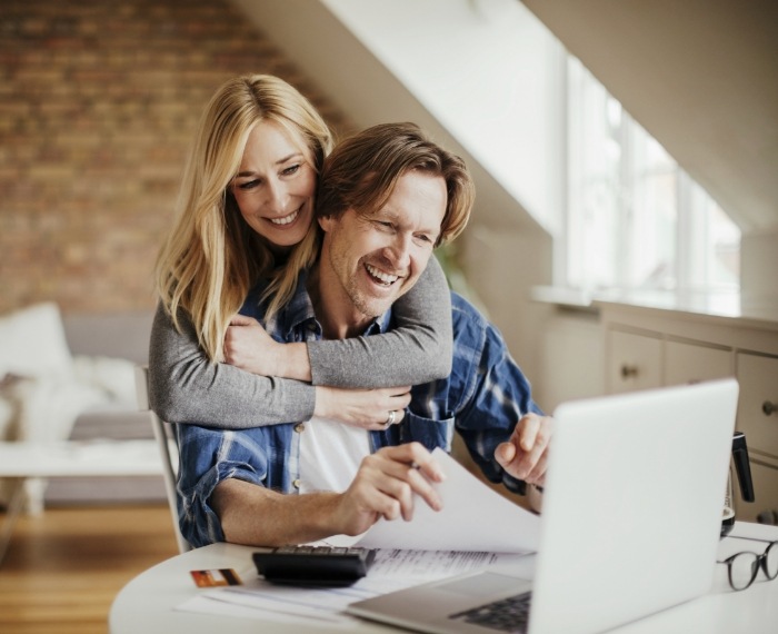 Man and woman looking on laptop for pediatric dentist reviews in Pleasanton