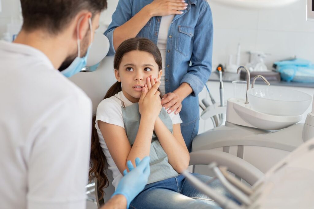 A little girl at the dentist with a toothache