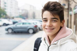 Pre-teen with braces smiling.
