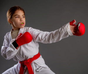 a karate kid with their mouthguard 